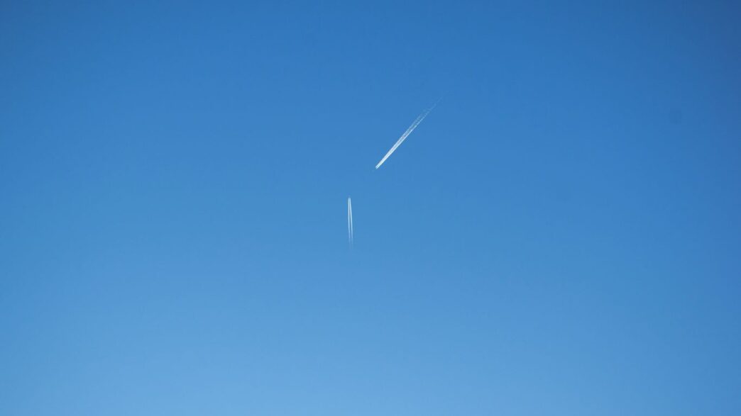 an airplane is flying high in the sky