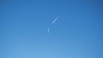 an airplane is flying high in the sky