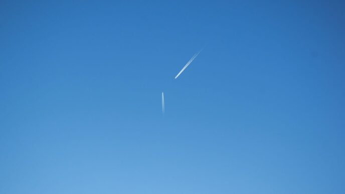 an airplane is flying high in the sky