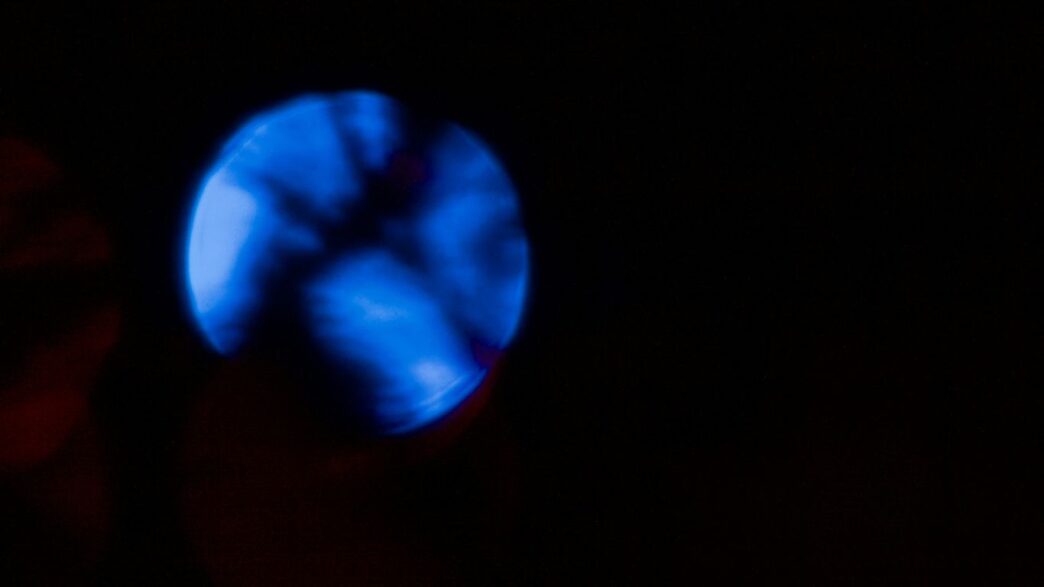 A glowing blue orb against a dark background.