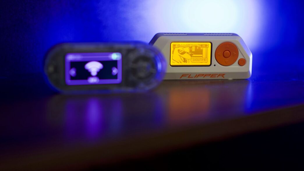 Two portable electronic devices on a reflective surface.