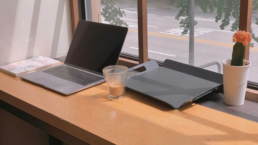 a laptop and a glass of water on a table