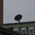 a satellite dish sitting on top of a building