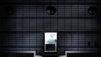 A bright doorway amidst a dark building.