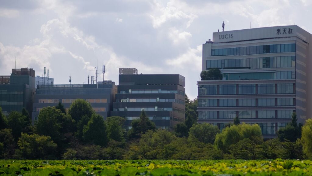 Modern office buildings behind lush green foliage