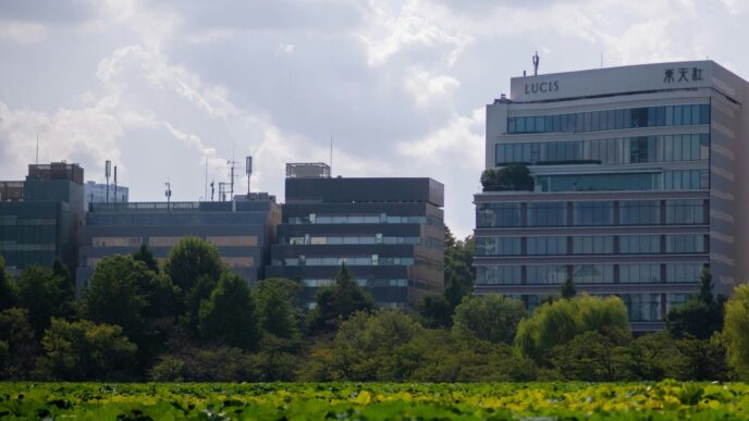Modern office buildings behind lush green foliage