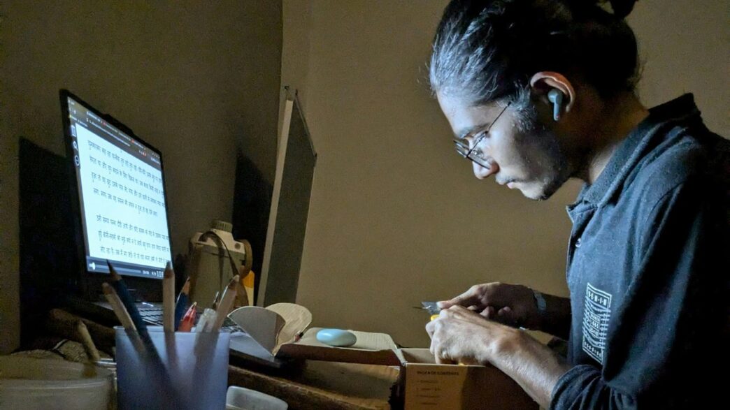 A woman sitting at a desk working on a computer