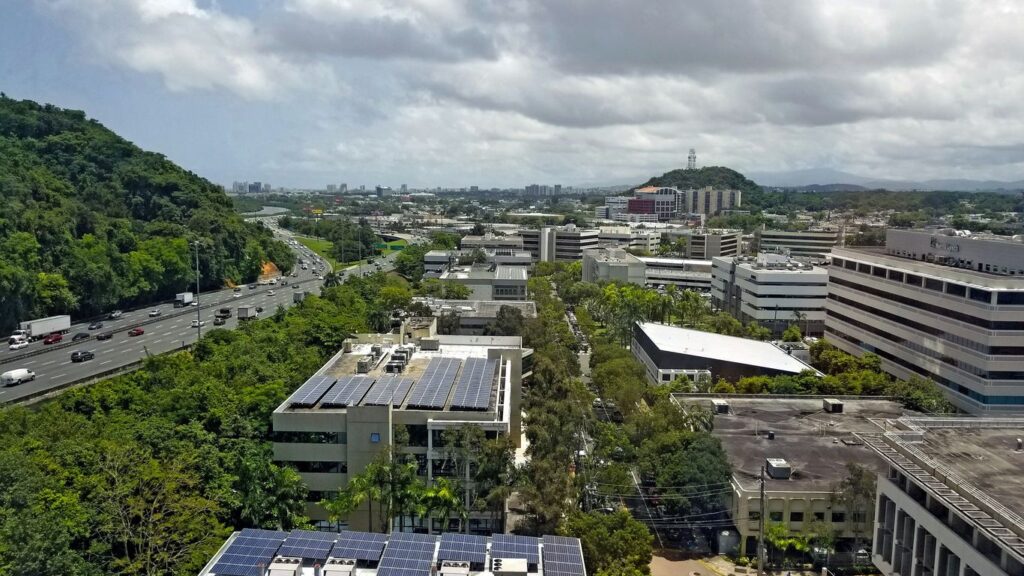 an aerial view of a city with solar panels