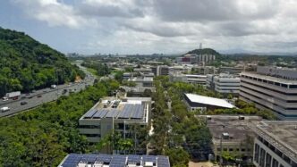 an aerial view of a city with solar panels
