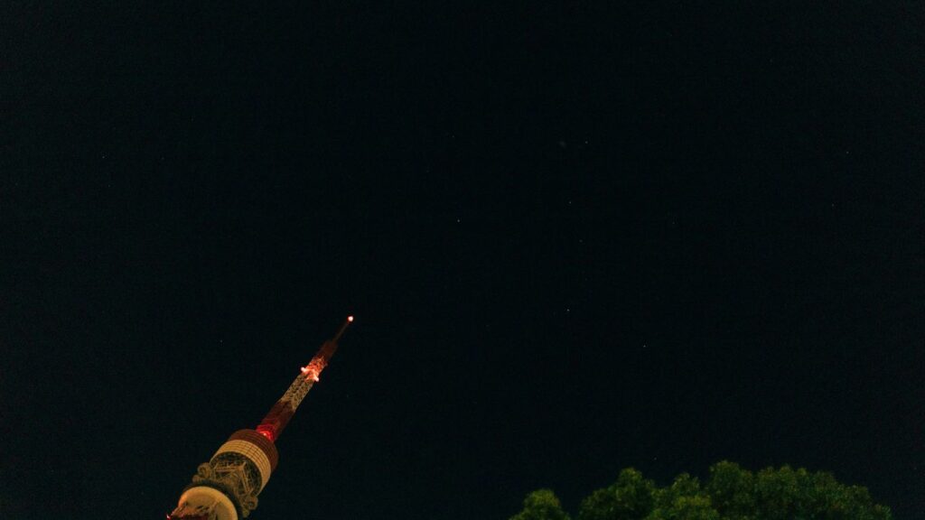 A very tall tower with a clock on it's side