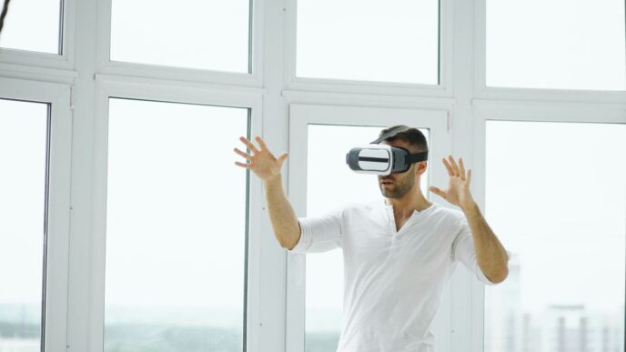 Man wearing vr headset with hands outstretched.