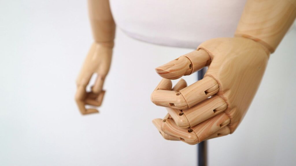 shallow focus photography of brown wooden puppet