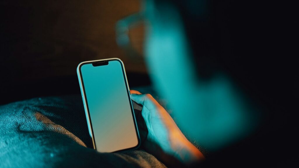 A person holding a cell phone in their hand