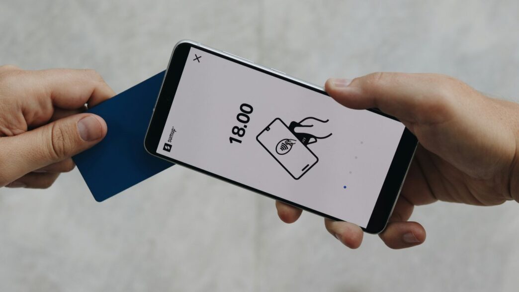 A person holding a cell phone in their hand