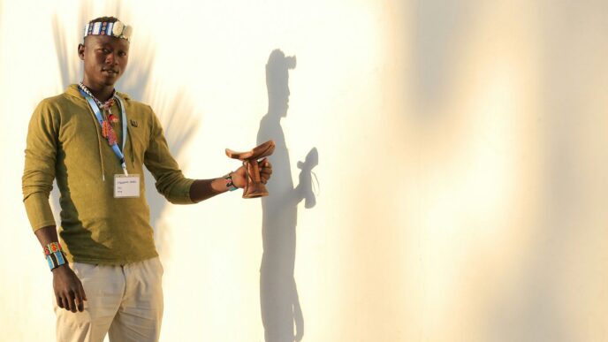 man in green button up shirt and white pants