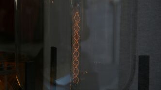 a close up of a glass door with a light in it