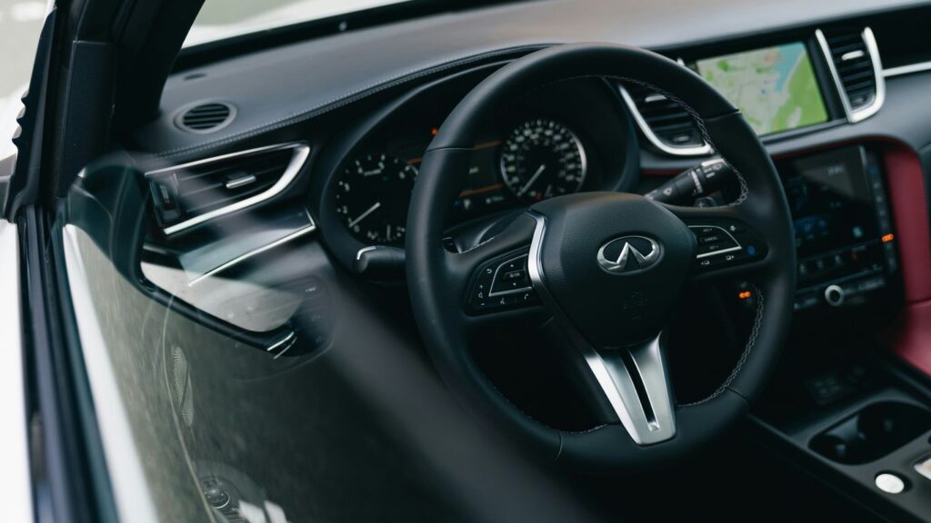 Modern car interior with leather seats and navigation screen.