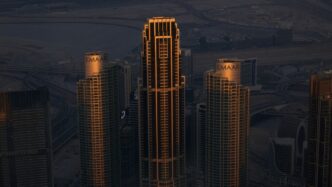 A view of a city at night from the top of a skyscraper