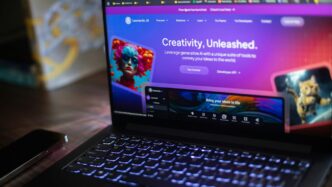 A laptop shows a website about ai creativity.