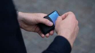 a person holding a cell phone in their hand