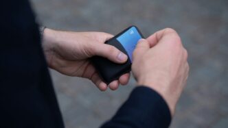 a person holding a cell phone in their hand