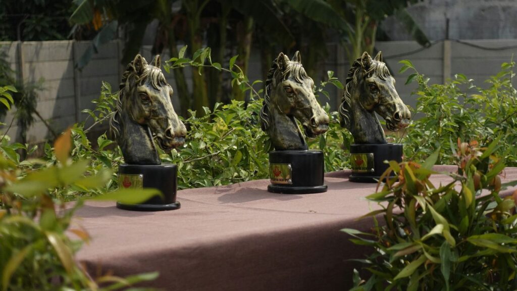 A table topped with lots of statues of horses