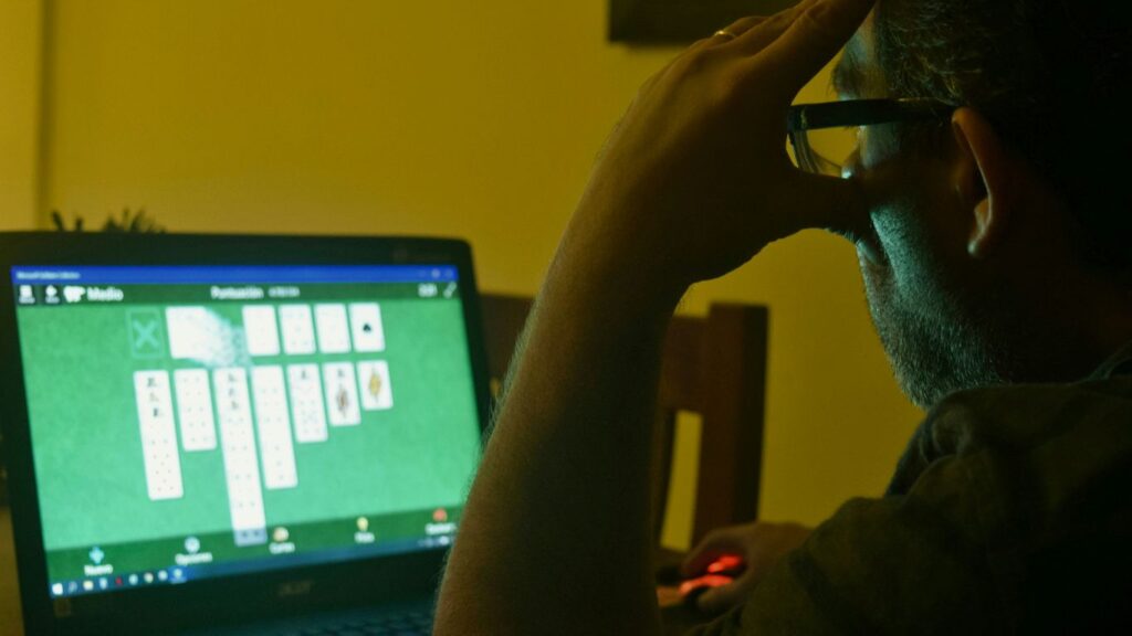 a man sitting in front of a laptop computer