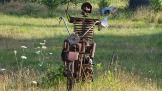 A sculpture of a man holding a flag on top of a motorcycle
