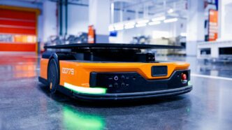 an orange and black vehicle in a garage