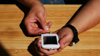 a person holding a smart phone in their hands