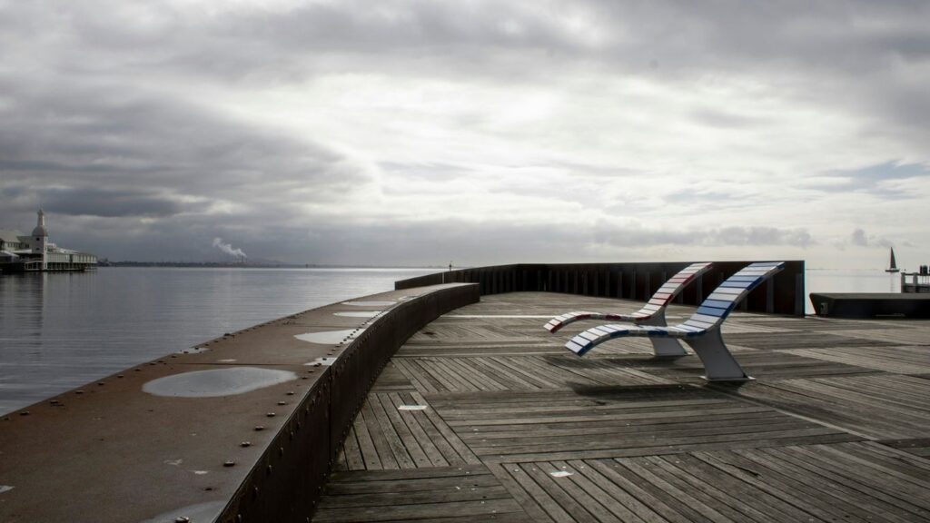 A bench sitting on top of a wooden pier