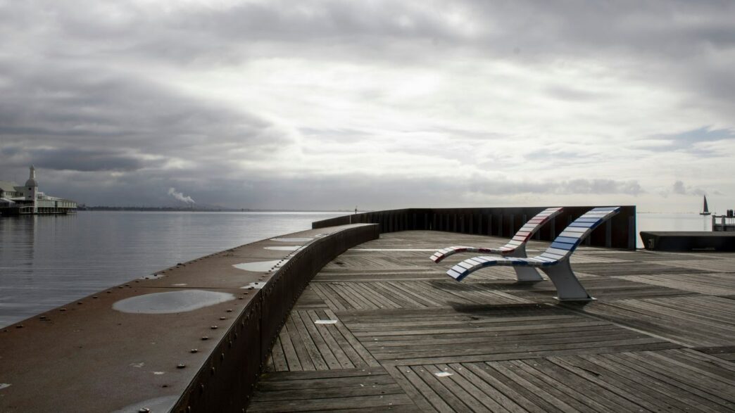 A bench sitting on top of a wooden pier