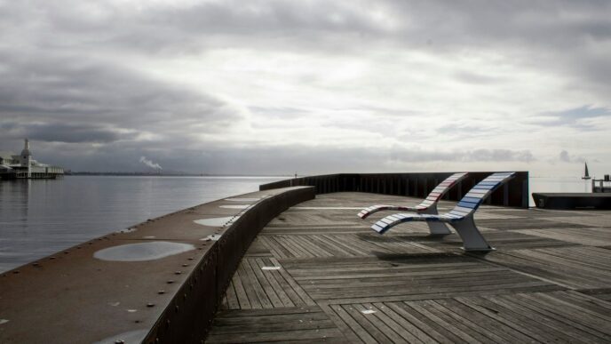 A bench sitting on top of a wooden pier
