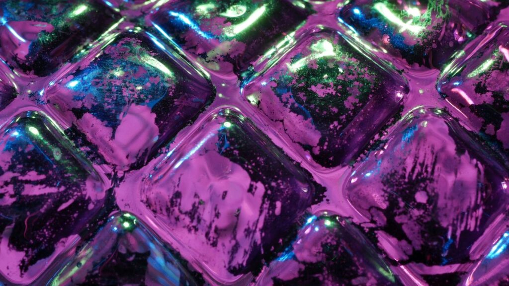 Close up of purple and green textured surface.