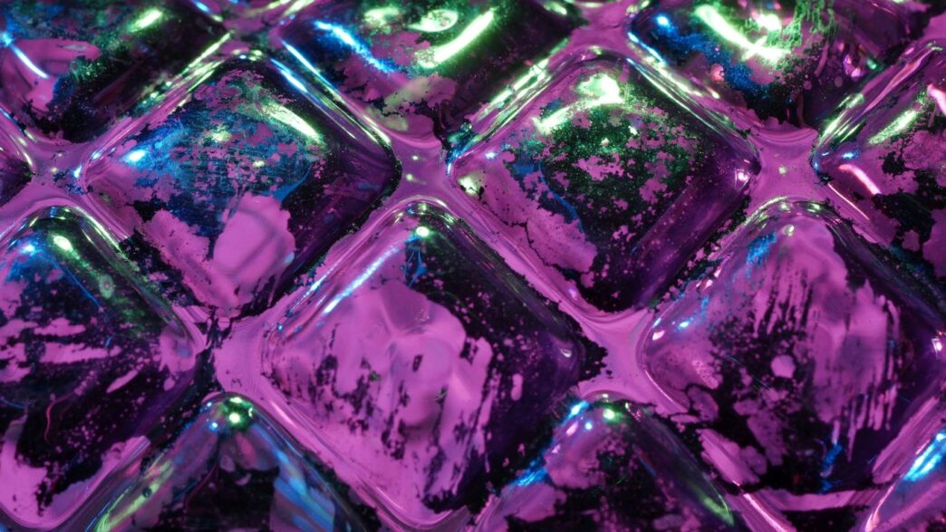 Close up of purple and green textured surface.