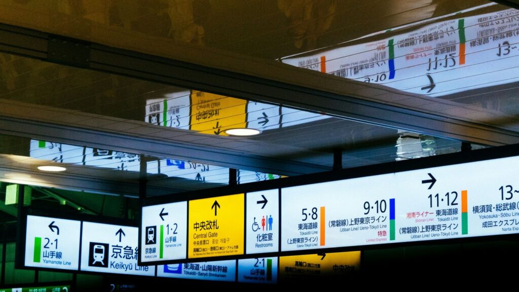 a bunch of signs hanging from the ceiling of a building
