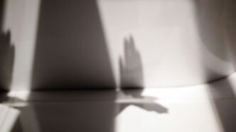 the shadow of a person's hand on a table