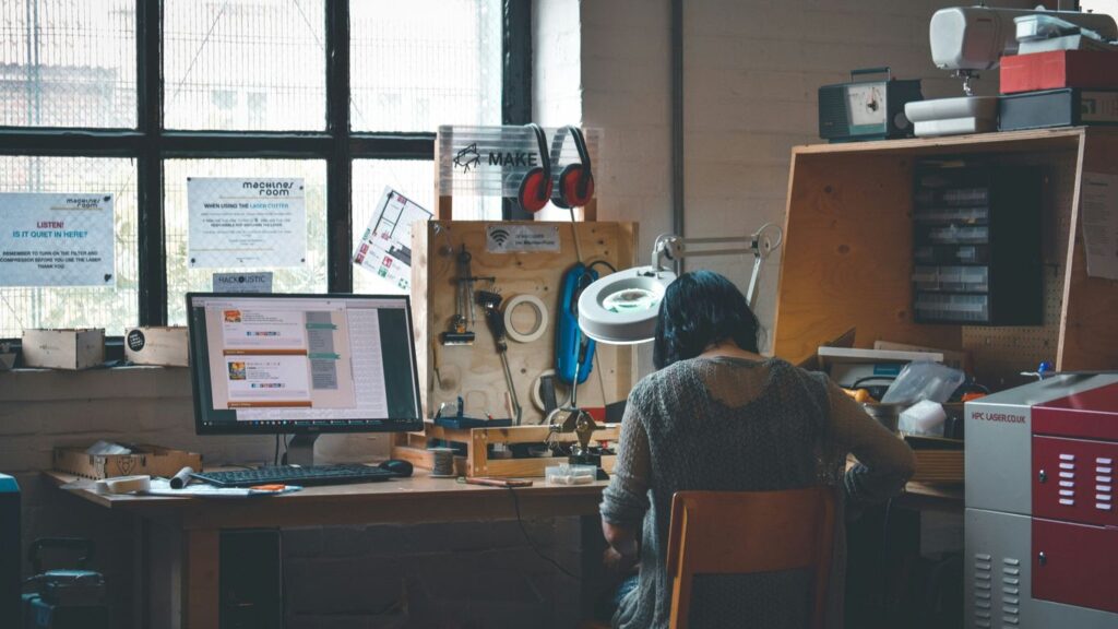 woman sitting in front of a wooden desk