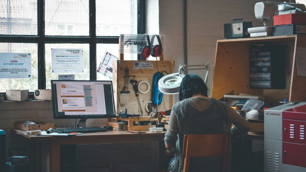 woman sitting in front of a wooden desk