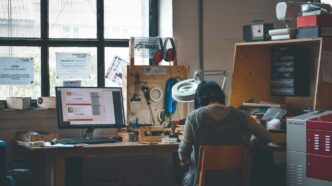 woman sitting in front of a wooden desk