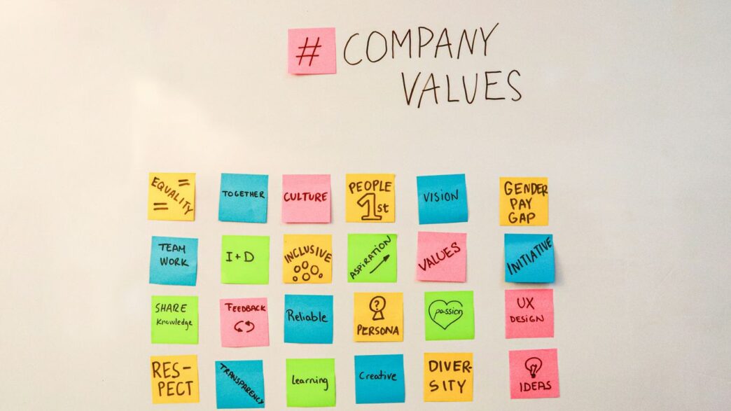 a white board with post it notes written on it