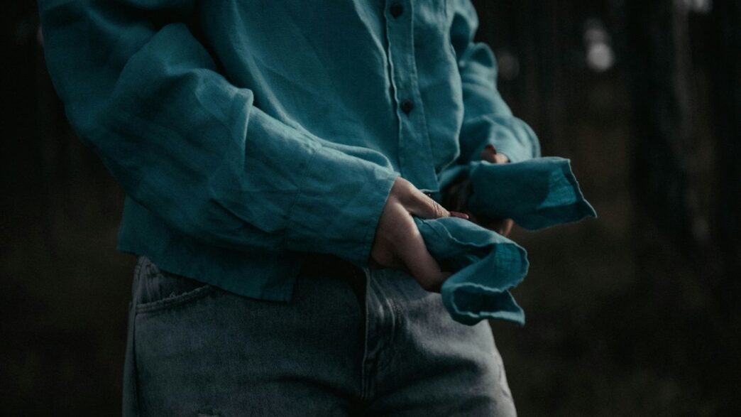 a person in a blue shirt is holding something in their hands