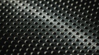 Close-up of a textured metal surface with many small holes.