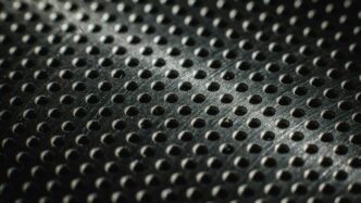 Close-up of a textured metal surface with many small holes.