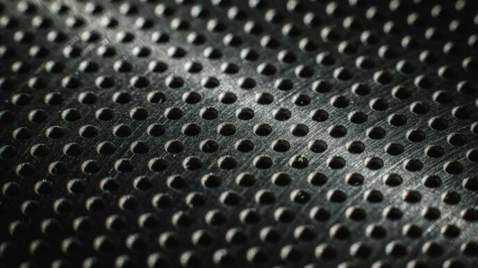 Close-up of a textured metal surface with many small holes.