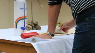 man leaning on table while flipping book page