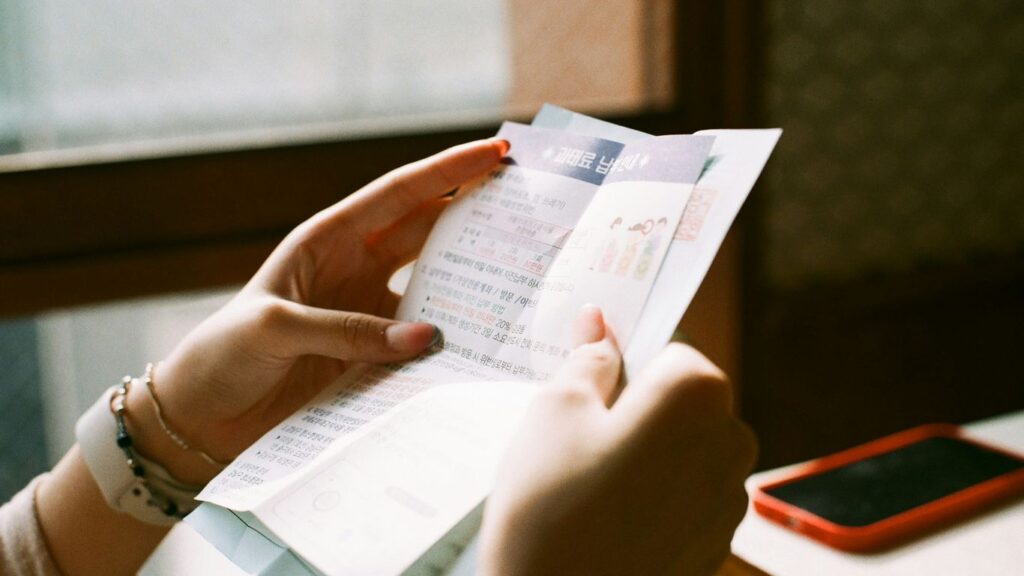 person holding white printer paper