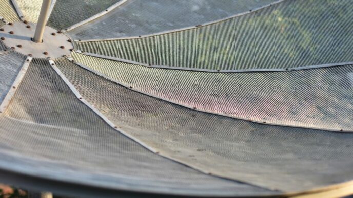 grey and white net on green grass during daytime