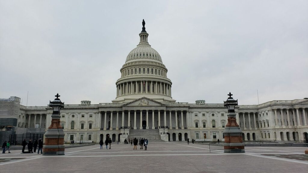 people walking on street near white concrete building during daytime