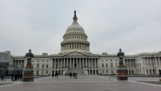 people walking on street near white concrete building during daytime